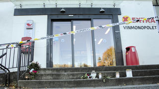15.10.2021, Norwegen, Kongsberg: Vor einem Geschäft, das in die Gewalttat in der norwegischen Kleinstadt Kongsberg verwickelt war, stehen Blumen und Kerzen. Der Mann, der fünf Menschen getötet haben soll, wird nun von Ärzten betreut. Das sagte die Staatsanwältin der norwegischen Zeitung «Verdens Gang» am heutigen Freitag. Foto: Terje Bendiksby/NTB/AP/dpa +++ dpa-Bildfunk +++