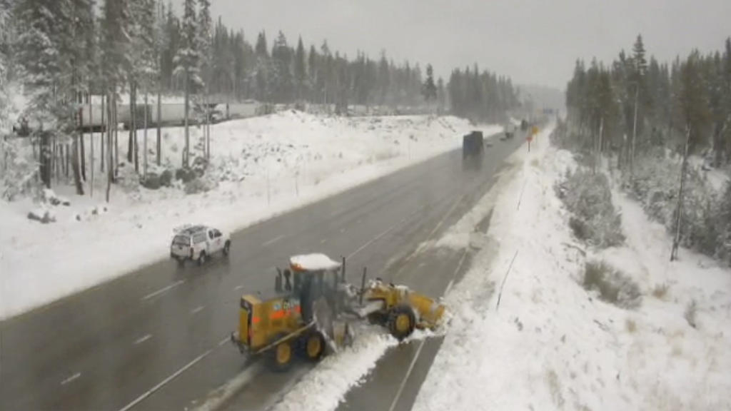 In this image from a Caltrans remote traffic video camera, snow is cleared from a shoulder lane along Interstate 80 at Donner Summit, Calif., Monday, Oct. 18, 2021. A cold front passing through drought-stricken California brought snow to the northern