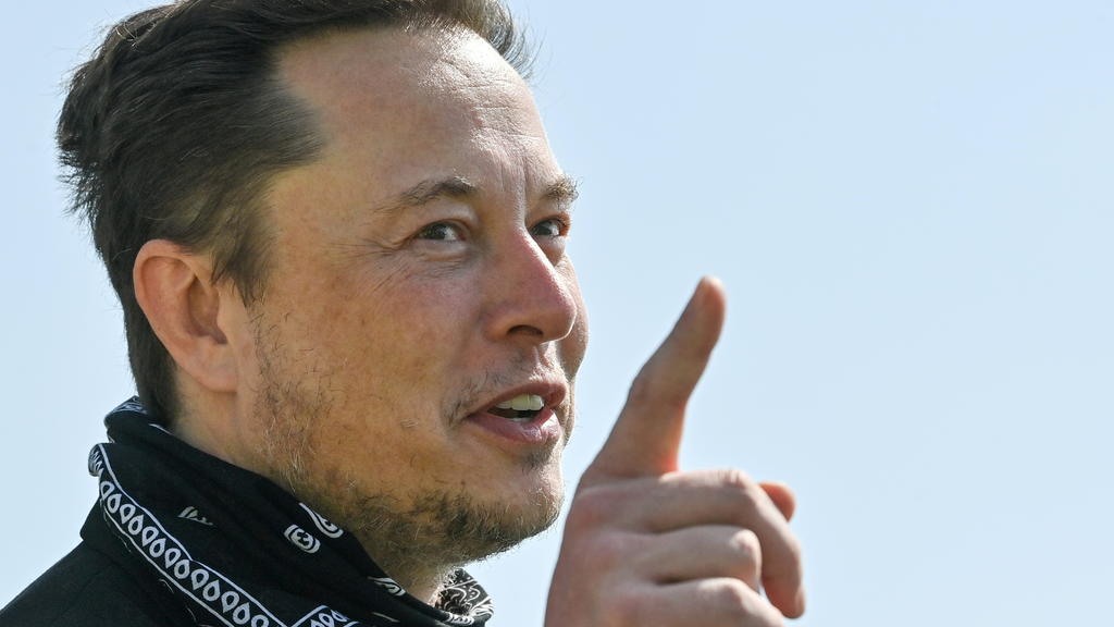FILE PHOTO: Tesla CEO Elon Musk gestures as he visits the construction site of Tesla's Gigafactory in Gruenheide near Berlin, Germany, August 13, 2021. Patrick Pleul/Pool via Reuters/File Photo