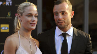 FILE - South African Olympic athlete Oscar Pistorius, right, and his girlfriend, the late Reeva Steenkamp, left, arrive at an awards ceremony in Johannesburg, South Africa. Nov. 4, 2012. Eight years after he shot dead his girlfriend, Pistorius is up for parole, but first he must meet with her parents as part of the parole procedure. A parole hearing for Pistorius was scheduled for last month and then canceled, partly because a meeting between Pistorius and Steenkamp's parents, Barry and June, had not been arranged, lawyers for both parties told The Associated Press on Monday, Nov. 8, 2021.  (Lucky Nxumalo/Citypress via AP, File)