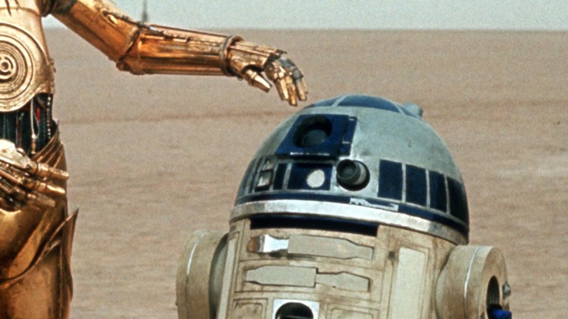 Die beiden Roboter C-3PO (l, Anthony Daniels) und R2-D2 (Kenny Baker) im zweiten Teil der "Star Wars"-Saga, "Das Imperium schlägt zurück" (Szenenfoto). 20 Jahre nach ihrem ersten Siegeszug kehrt die Weltraum-Trilogie von George Lucas nach technischer