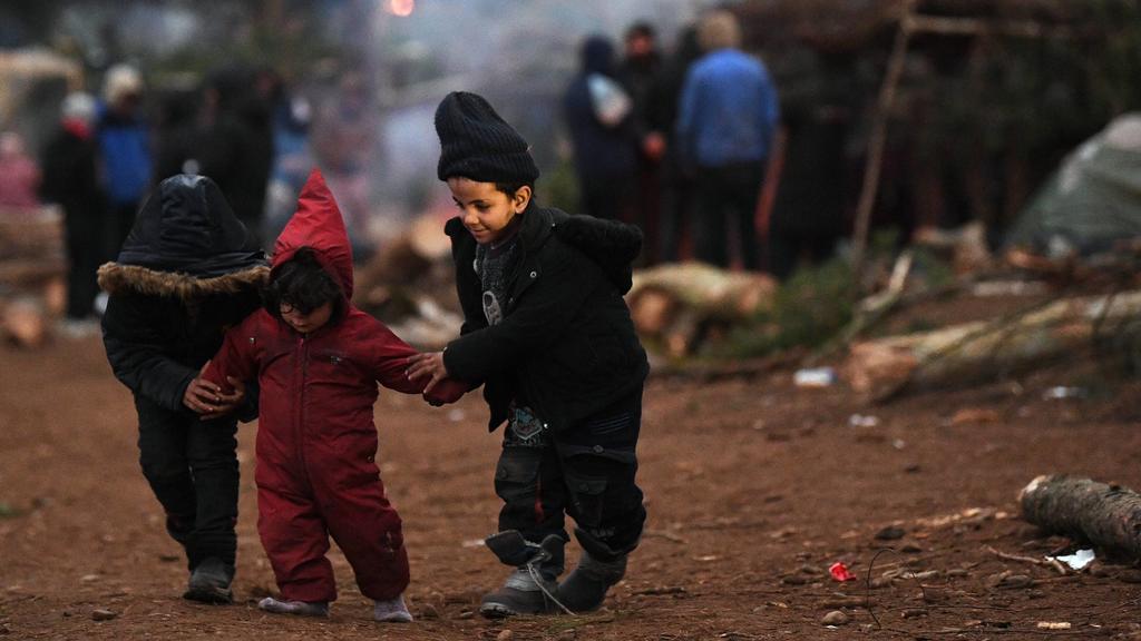Belarus Poland Border Refugees 6695843 15.11.2021 Refugee children are seen at a migrant camp on the Belarusian-Polish border in Grodno region, Belarus. Migrants from the Middle East and North Africa trapped in Belarus have converged on the border w