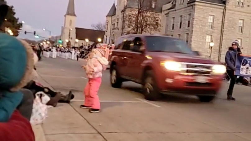 An SUV speeds past moments before plowing into a crowd of people during a Christmas parade in Waukesha, Wisconsin, U.S., in this still image taken from a November 21, 2021 social media video. JESUS OCHOA/via REUTERS THIS IMAGE HAS BEEN SUPPLIED BY A 