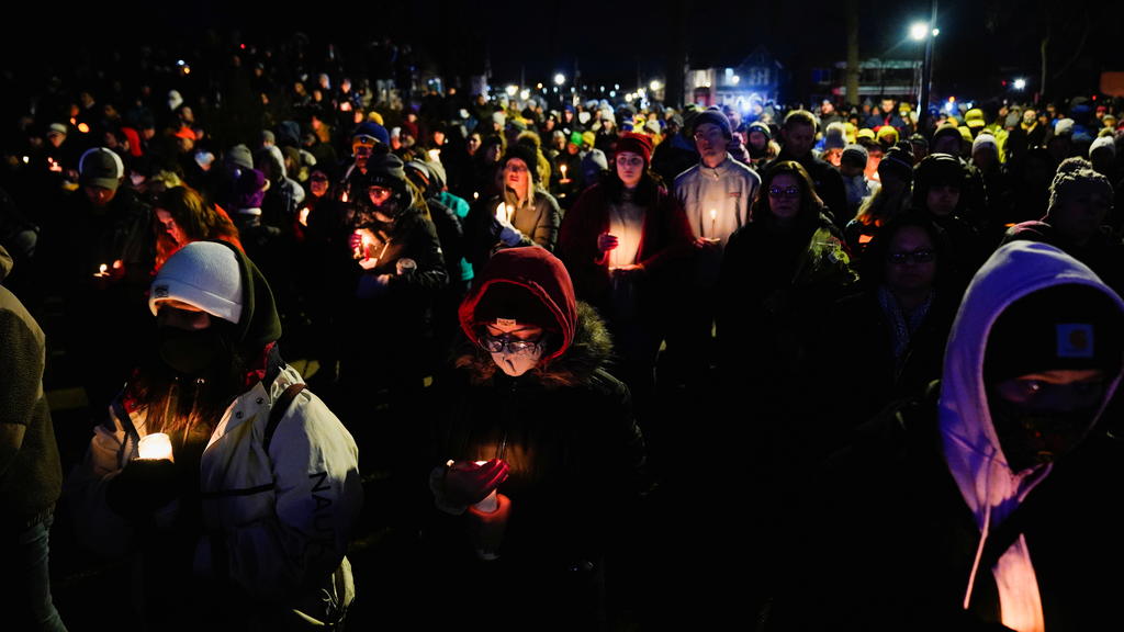 Community members mourn during a candle light vigil in Cutler Park after a car plowed through a holiday parade in Waukesha, Wisconsin, U.S., November 22, 2021. REUTERS/Cheney Orr