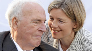 FILE - Former German Chancellor Helmut Kohl, left, talks with his wife Maike Kohl-Richter after unveiling of a memorial stone to honour Kohl's work for the German reunification in Moedlareuth, Germany, May 21, 2013. A German federal court ruled on Monday that the widow of former Chancellor Angela Kohl isn't entitled to 1 million euros, 1.1 million Dollars, in damages that the country's late leader was awarded in a legal battle with his one-time ghostwriter. Kohl was awarded the damages shortly before he died in 2017 by a Cologne court, which found that the ghostwriter had violated his privacy rights. (AP Photo/Jens Meyer, File)