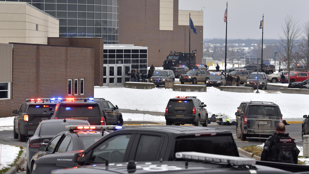 Dozens of police, fire, and EMS personnel work on the scene of a shooting at Oxford High School, Tuesday, Nov. 30, 2021, In Oxford Township, Mich. (Todd McInturf/The Detroit News via AP)