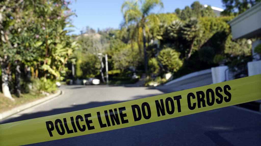 Police tape blocks the intersection of Maytor Place and Barrie Drive in the Trousdale Estates section of Beverly Hills, Calif., Wednesday, Dec. 1, 2021. Jacqueline Avant, the wife of music legend Clarence Avant, was fatally shot in the neighborhood e