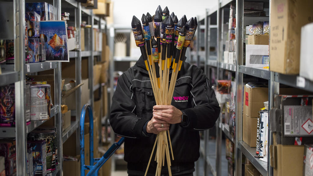 Ein Mitarbeiter von Weco, Hersteller von Feuerwerk, hält in einem Lagerraum Silvesterraketen.