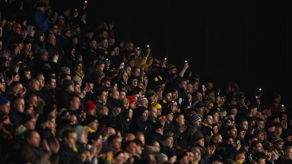 WATFORD, ENGLAND - DECEMBER 04: Fans of Watford hold a minutes applause in memory of Arthur Labinjo-Hughes during the Premier League match between Watford and Manchester City at Vicarage Road on December 04, 2021 in Watford, England. (Photo by Richar
