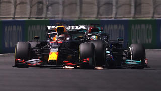 JEDDAH, SAUDI ARABIA - DECEMBER 05: Max Verstappen of the Netherlands driving the (33) Red Bull Racing RB16B Honda and Lewis Hamilton of Great Britain driving the (44) Mercedes AMG Petronas F1 Team Mercedes W12 collide during the F1 Grand Prix of Saudi Arabia at Jeddah Corniche Circuit on December 05, 2021 in Jeddah, Saudi Arabia. (Photo by Lars Baron/Getty Images)