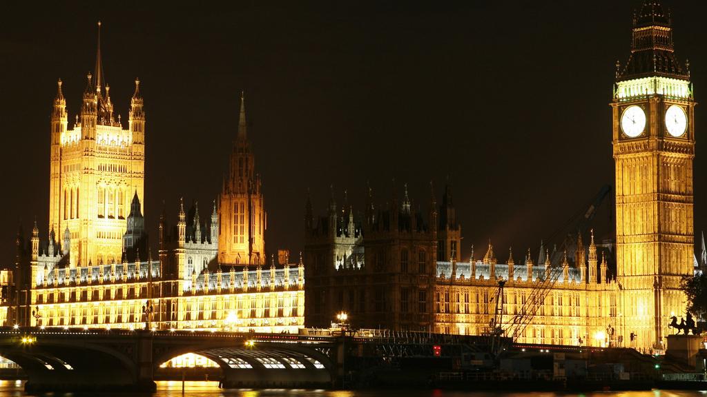 Blick zum erleuchteten Palace of Westminster (Houses of Parliament) am nördlichen Themse-Ufer in London mit dem Victoria Tower (l./98,45 Meter hoch), dem Central Tower (2.v.l./91,44) und dem Clock Tower (r./96,32) mit der Glocke Big Ben, aufgenommen 