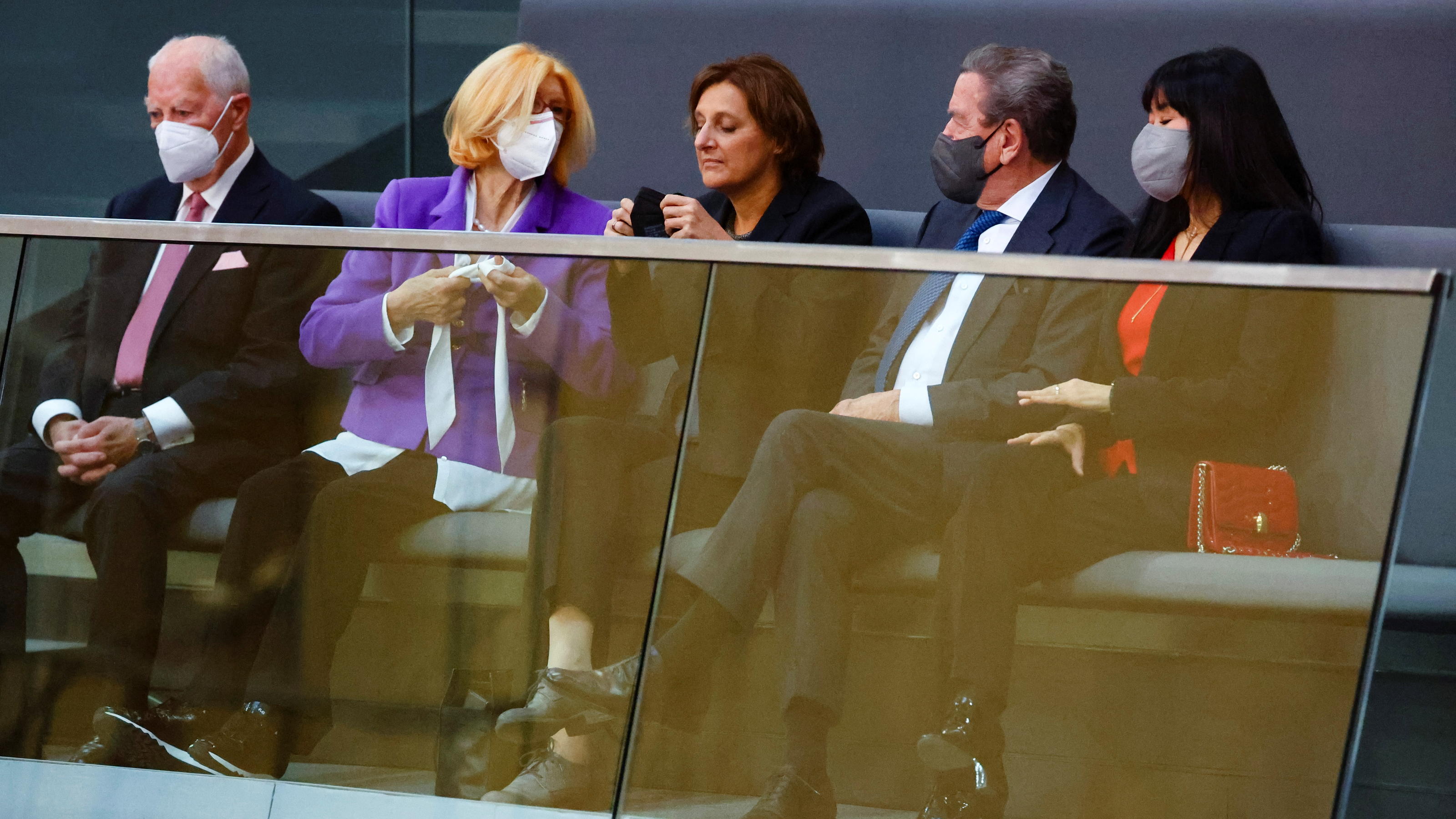 Britta Ernst, wife of designated German Chancellor Olaf Scholz, sits next to former German chancellor Gerhard Schroeder and his wife Kim So-yeon in the visitors tribune before the start of a session of the German lower house of parliament Bundestag t