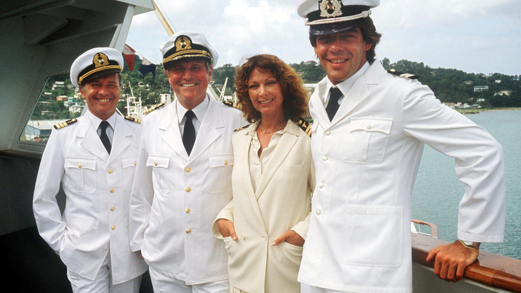 Die «Traumschiff»-Crew von 1983 (l-r) Horst Naumann als Schiffsarzt, Heinz Weiss als Kapitän, Heide Keller als Stewardess und Sascha Hehn als Steward.