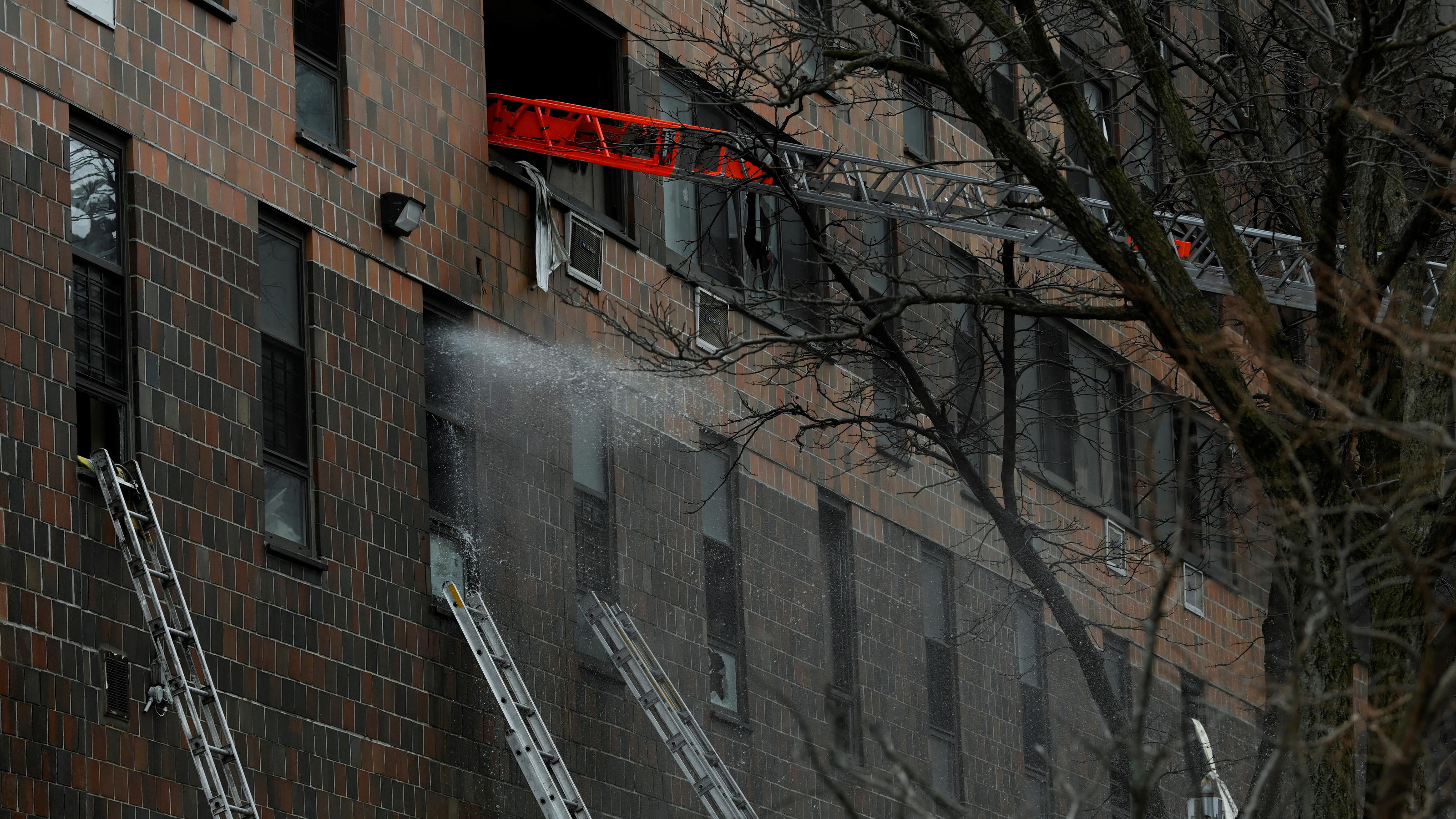 Emergency personnel from the FDNY respond to an apartment building fire in the Bronx borough of New York City, U.S., January 9, 2022.  REUTERS/Lloyd Mitchell
