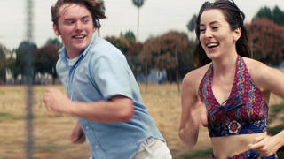This image released by MGM shows Cooper Hoffman, left, and Alana Haim in a scene from "Licorice Pizza." (MGM via AP)