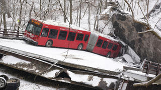 This is a Pittsburgh Transit Authority bus that was on the Fern Hollow Bridge in Pittsburgh when it collapsed Friday morning Friday, Jan. 28, 2022. (AP Photo/Gene J. Puskar)