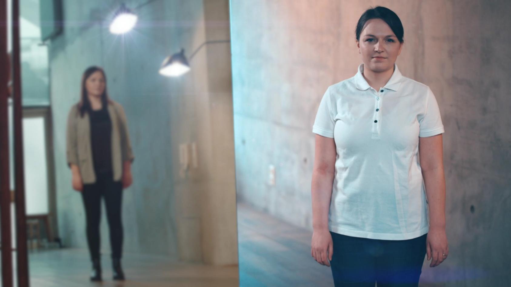 Journalistin Judith ist links im Spiegelbild zu sehen, während rechts Pflegepraktikantin Judith in einem weißen Poloshirt direkt in die Kamera blickt.