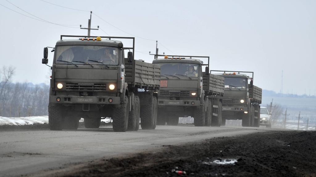 Russia Ukraine Military Operation 8128657 28.02.2022 Military trucks drive along a road near the border between Russia and Ukraine in Belgorod region, Russia. On February 24 Russian President Vladimir Putin announced a military operation in Ukraine
