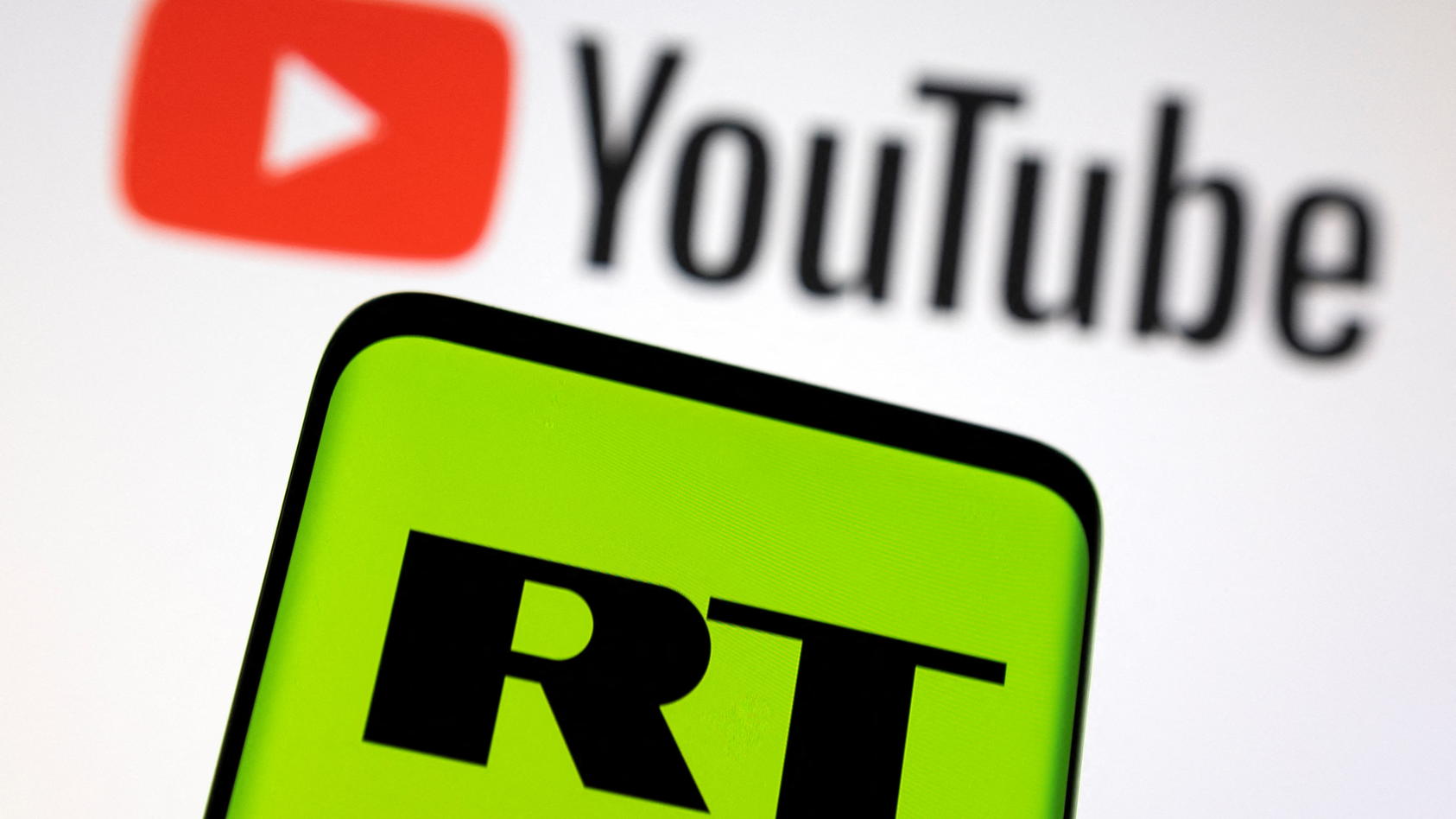 Russia Today (RT) logo is seen on a smartphone in front of displayed Youtube logo in this illustration picture taken February 26, 2022. REUTERS/Dado Ruvic/Illustration