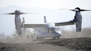 Members of the Japan Ground Self-Defense Force (JGSDF) rush out from a V-22 osprey as they take part in a joint military helicopter borne operation drill between Japan Ground Self-Defense Force (JGSDF) and U.S. Marines at the Higashi Fuji range in Gotemba, southwest of Tokyo, Tuesday, March 15, 2022. (AP Photo/Eugene Hoshiko)