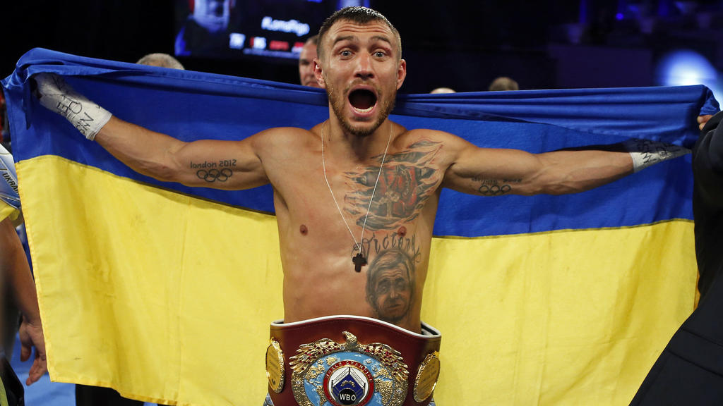 FILE - Vasiliy Lomachenko, of Ukraine, celebrates after defeating Guillermo Rigondeaux in a WBO junior lightweight title boxing match in New York, Dec. 9, 2017. Former heavyweight champions Vitali and Wladimir Klitschko are leading some of the resist