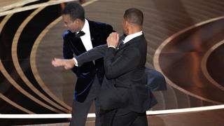 Will Smith (R) hits Chris Rock as Rock spoke on stage during the 94th Academy Awards in Hollywood, Los Angeles, California, U.S., March 27, 2022. Picture taken March 27, 2022. REUTERS/Brian Snyder BEST AVAILABLE QUALITY