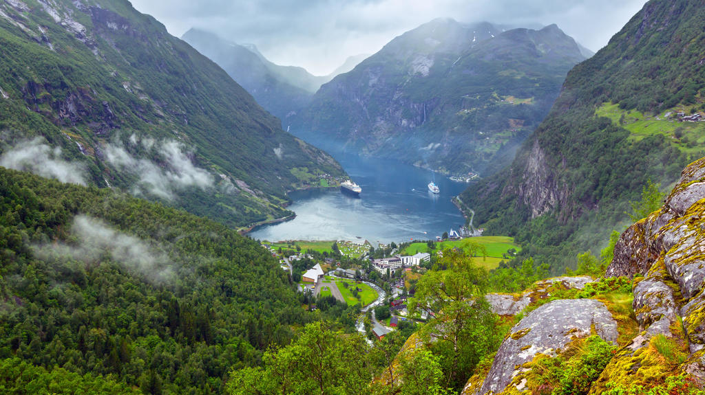 Geiranger Fjord cloudy summer panorama from above Dalsnibba mount, Norway.