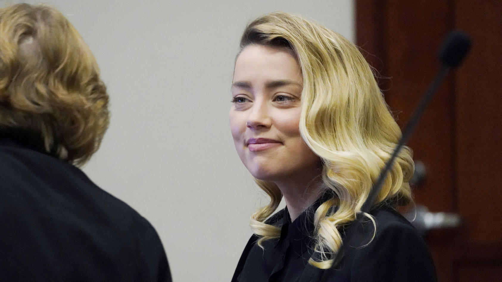 Actress Amber Heard talks to her attorney in the courtroom at the Fairfax County Circuit Court in Fairfax, Va., Monday April 18, 2022. Actor Johnny Depp sued his ex-wife Amber Heard for libel in Fairfax County Circuit Court after she wrote an op-ed p
