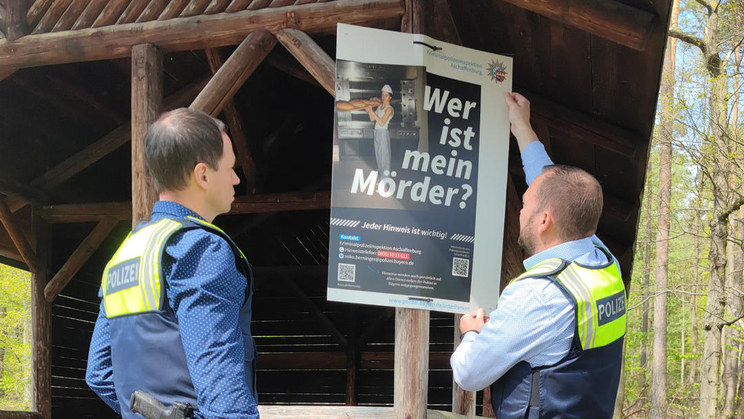 HANDOUT - 25.04.2022, Bayern, Wörth am Main: Ermittler hängen Hinweisschilder zum Fall Klaus Berninger auf. Der Bäckerlehrling war 1990 in Unterfranken verschwunden. Die Polizei geht davon aus, dass er getötet wurde. In den letzten Tagen hing die Pol