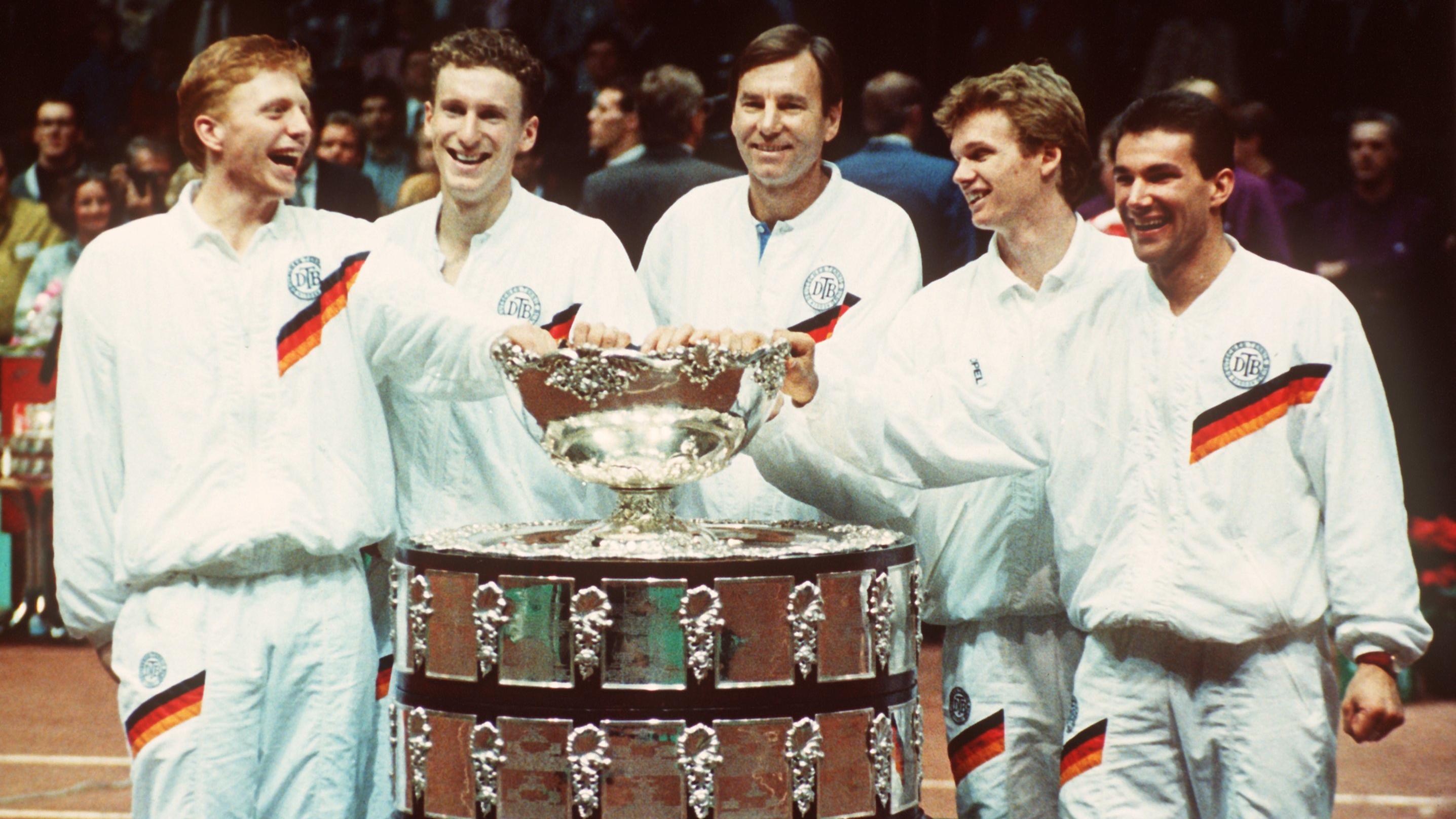 Der deutsche Daviscup-Kapitän Niki Pilic (M) steht mit seinen Tennisstars (l-r) Boris Becker, Patrick Kühnen, Eric Jelen und Carl-Uwe Steeb in Göteborg hinter der Daviscup-Trophäe (Archivfoto vom 16.12.1988). 