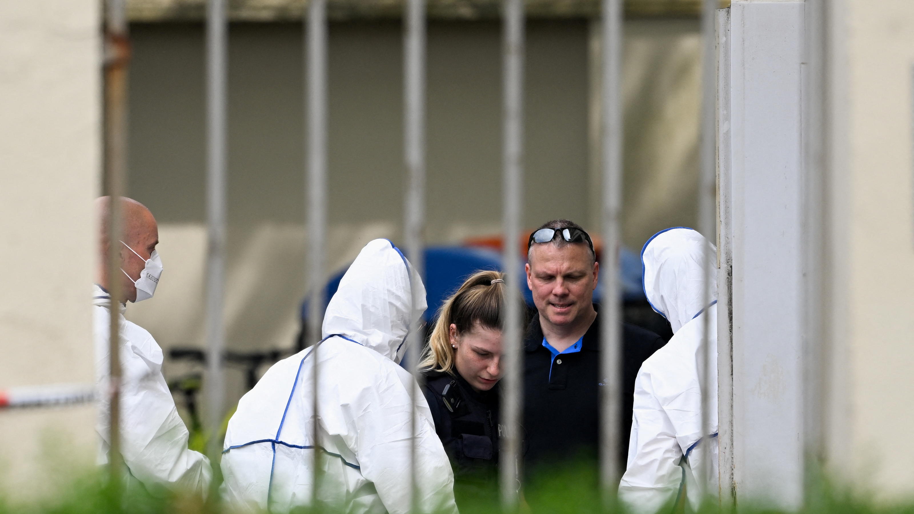 Forensic experts and police officers are seen near the building of a school where shots were fired, in the northern city of Bremerhaven, Germany, May 19, 2022. REUTERS/Fabian Bimmer