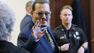 Actor Johnny Depp gestures to the gallery in the courtroom as he leaves for the day at the Fairfax County Circuit Courthouse in Fairfax, Va., Monday, May 23, 2022. Depp sued his ex-wife Amber Heard for libel in Fairfax County Circuit Court after she wrote an op-ed piece in The Washington Post in 2018 referring to herself as a "public figure representing domestic abuse." (AP Photo/Steve Helber, Pool)