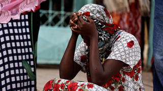 Kaba, a mother of a ten-day-old baby, reacts as she sits outside the hospital, where newborn babies died in a fire at the neonatal section of a regional hospital in Tivaouane, Senegal, May 26, 2022. REUTERS/Zohra Bensemra