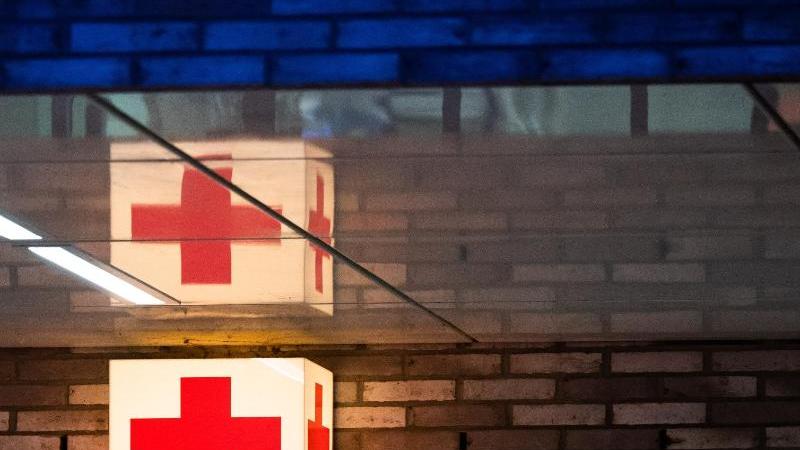 ein-leuchtkasten-mit-einem-roten-kreuz-hangt-vor-der-notaufnahme-eines-krankenhauses-foto-julian-stratenschultedpasymbolbild