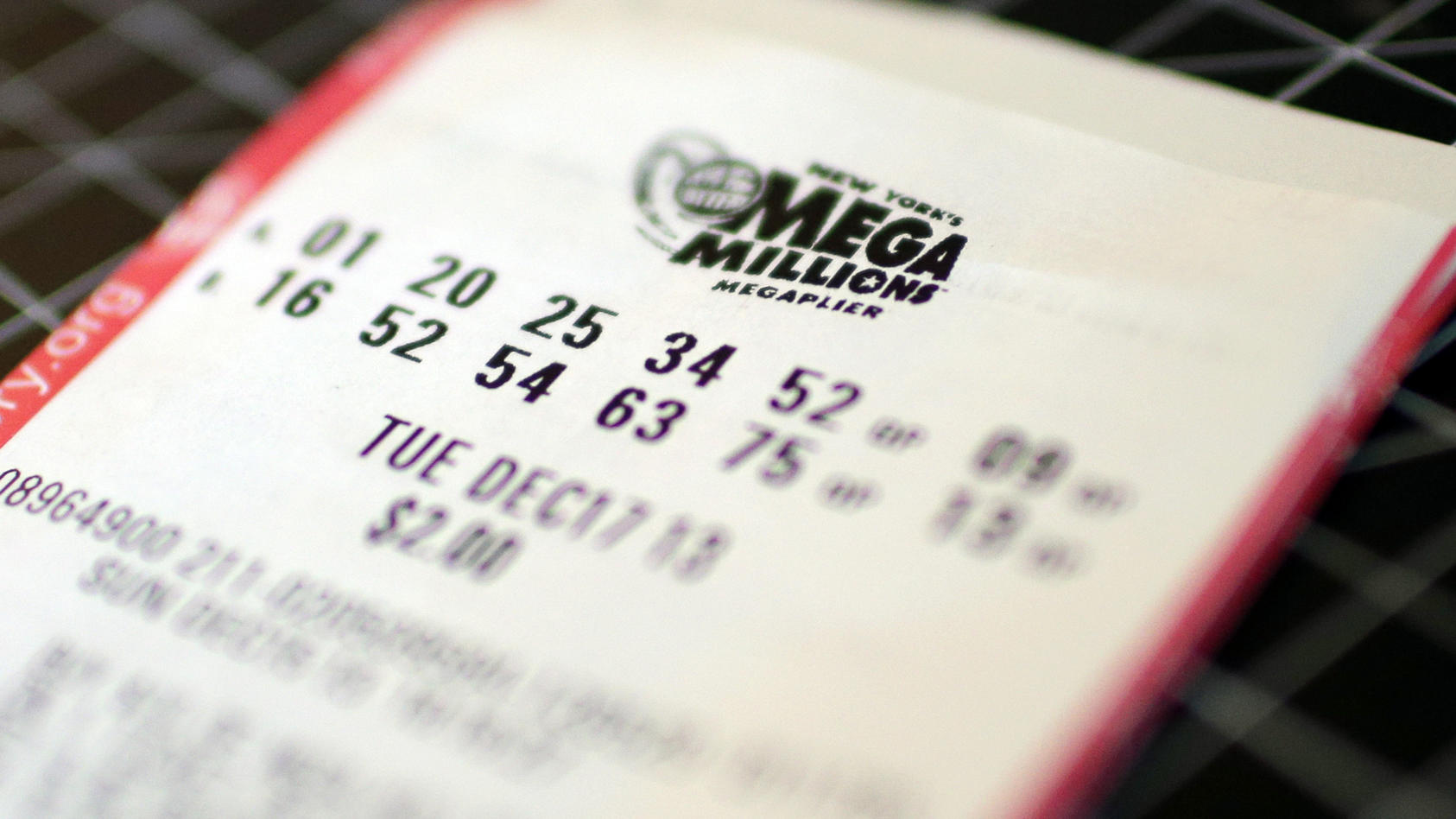 Image #: 26078533    Two Mega Millions tickets for the Tuesday December 17th jackpot lay one on top of the other In New York City on December 16, 2013. The Mega Millions jackpot has been boosted to $586 million, a jump from the earlier projection but