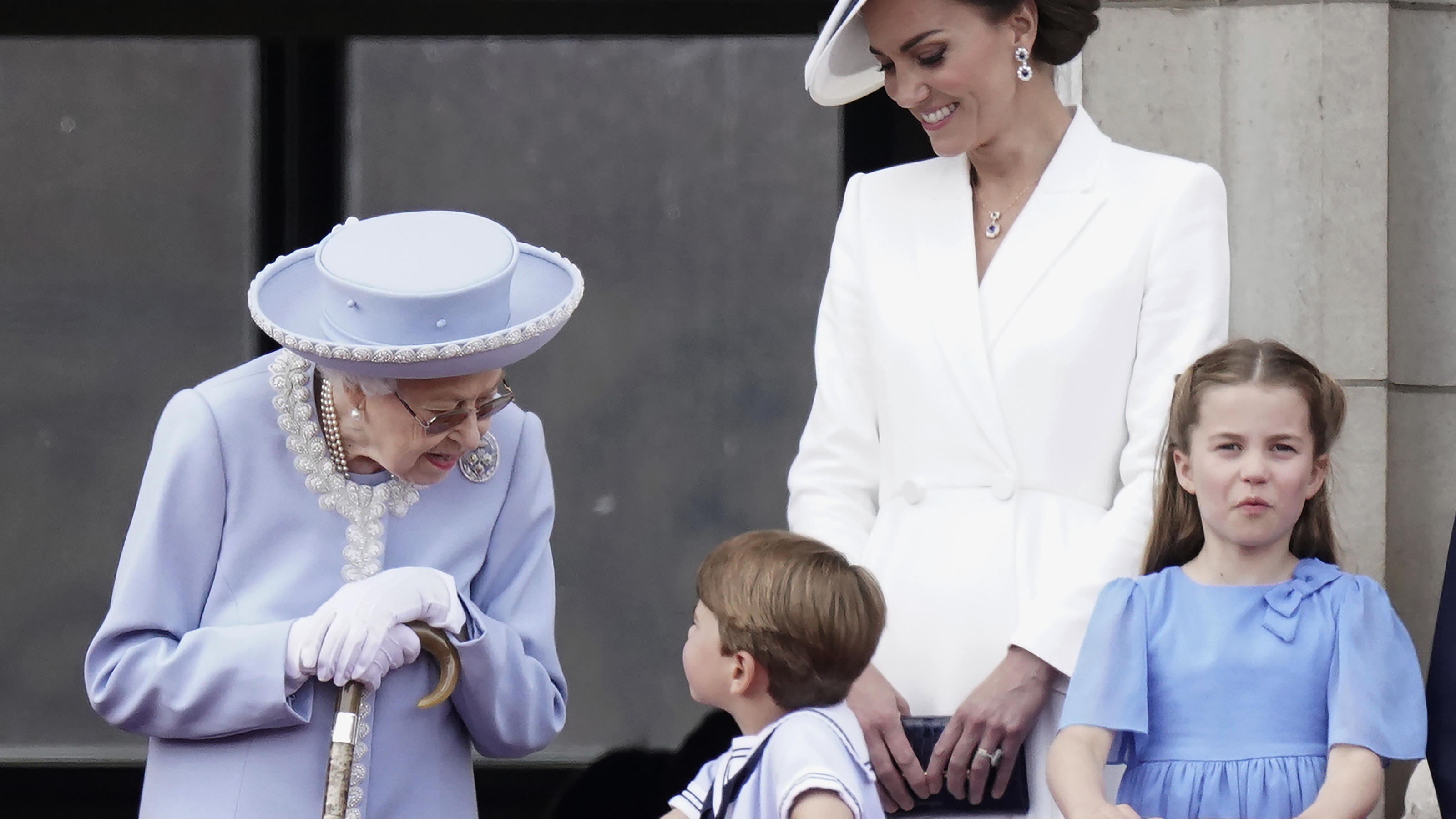 Queen Elizabeth II, Kate, Duchess of Cambridge, Prince Louis, Princess Charlotte watch from the balcony of Buckingham Place after the Trooping the Color ceremony in London, Thursday, June 2, 2022, on the first of four days of celebrations to mark the