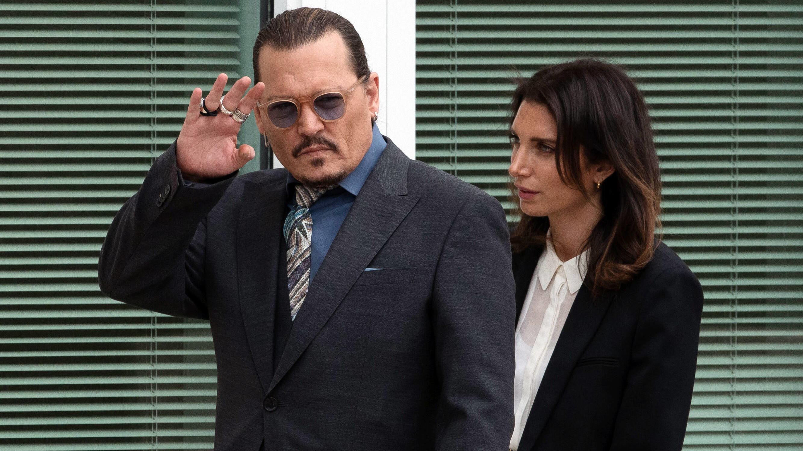  Johnny Depp steps outside the Fairfax County Courthouse, in Fairfax, during a recess in the civil trial between him and Amber Heard, Wednesday, May 25, 2022. Depp brought a defamation lawsuit against his former wife, actress Amber Heard, after she w