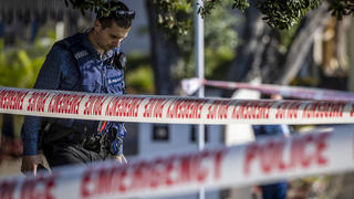 Police set up a cordon and search area in a suburb of Auckland following reports of multiple stabbings, in New Zealand, Thursday, June 23, 2022. Authorities say a man wounded some people in a stabbing rampage in a New Zealand city before bystanders brought him to the ground. (Michael Craig/New Zealand Herald via AP)