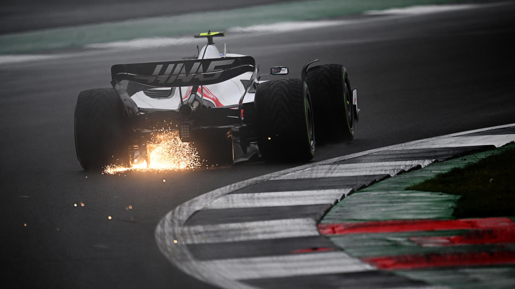 NORTHAMPTON, ENGLAND - JULY 02: Sparks fly behind Mick Schumacher of Germany driving the (47) Haas F1 VF-22 Ferrari during qualifying ahead of the F1 Grand Prix of Great Britain at Silverstone on July 02, 2022 in Northampton, England. (Photo by Clive