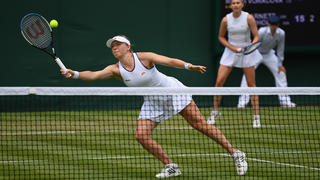 LONDON, ENGLAND - JUNE 29: Alicia Barnett plays a forehand with partner (obscured) Olivia Nicholls of Great Britain against Kaia Kanepi of Estonia and Renata Voracova of Czech Republic during the Women's Doubles First Round match on day three of The Championships Wimbledon 2022 at All England Lawn Tennis and Croquet Club on June 29, 2022 in London, England. (Photo by Justin Setterfield/Getty Images)
