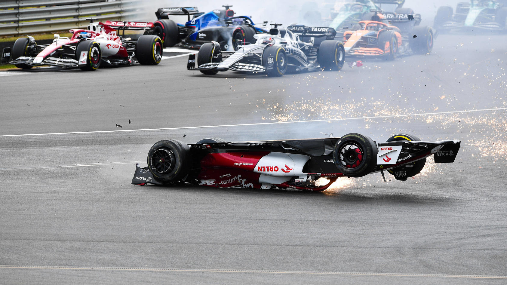 Sport Bilder des Tages 220704 -- LONDON, July 4, 2022 -- Alfa Romeo s Chinese driver Zhou Guanyu crashes out at the start of the Formula One British Grand Prix at the Silverstone motor racing, Motorsport circuit in Silverstone, Britain, on July 3, 20
