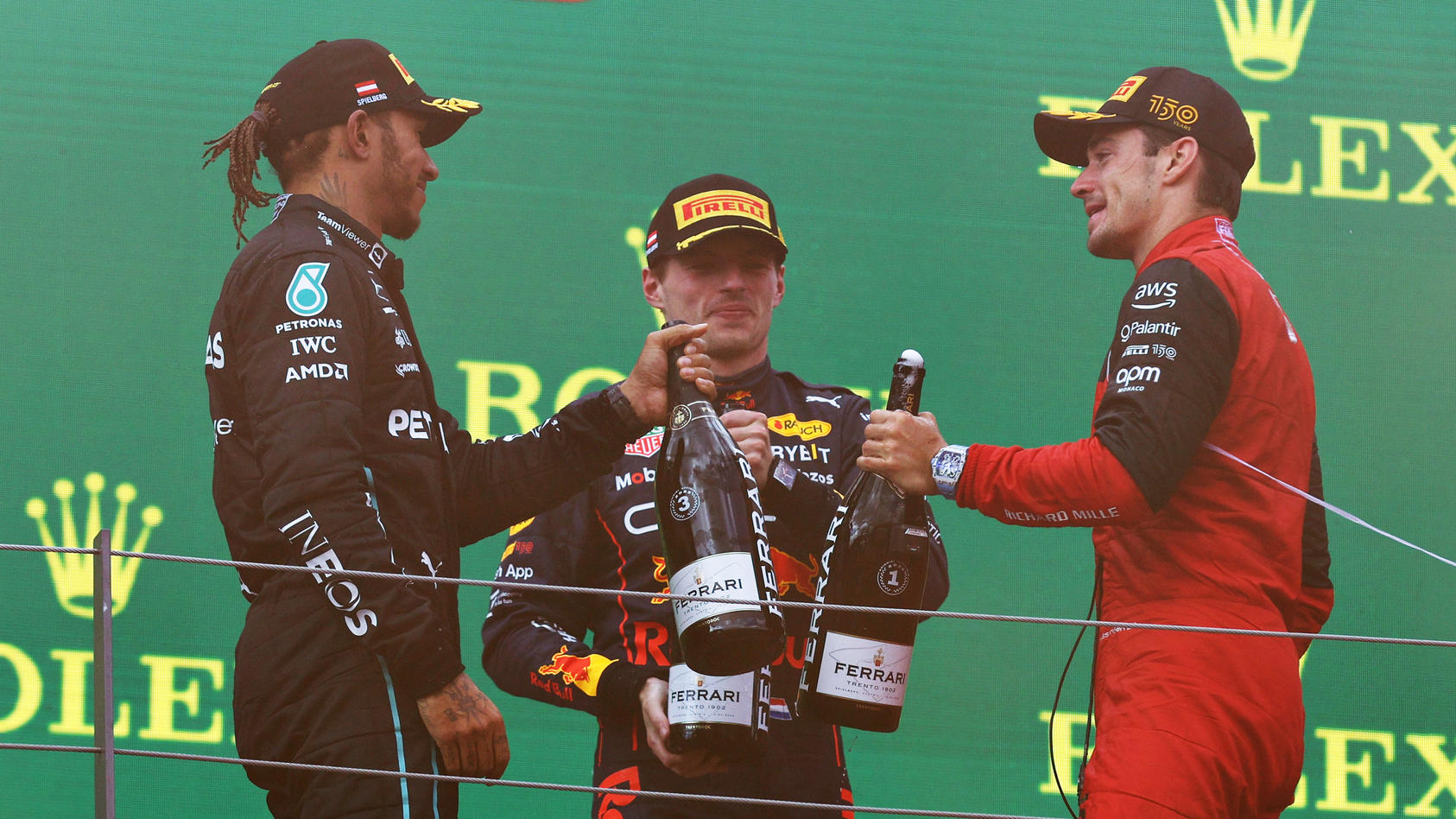 SPIELBERG, AUSTRIA - JULY 10: Race winner Charles Leclerc of Monaco and Ferrari, Second placed Max Verstappen of the Netherlands and Oracle Red Bull Racing and Third placed Lewis Hamilton of Great Britain and Mercedes celebrate on the podium during t
