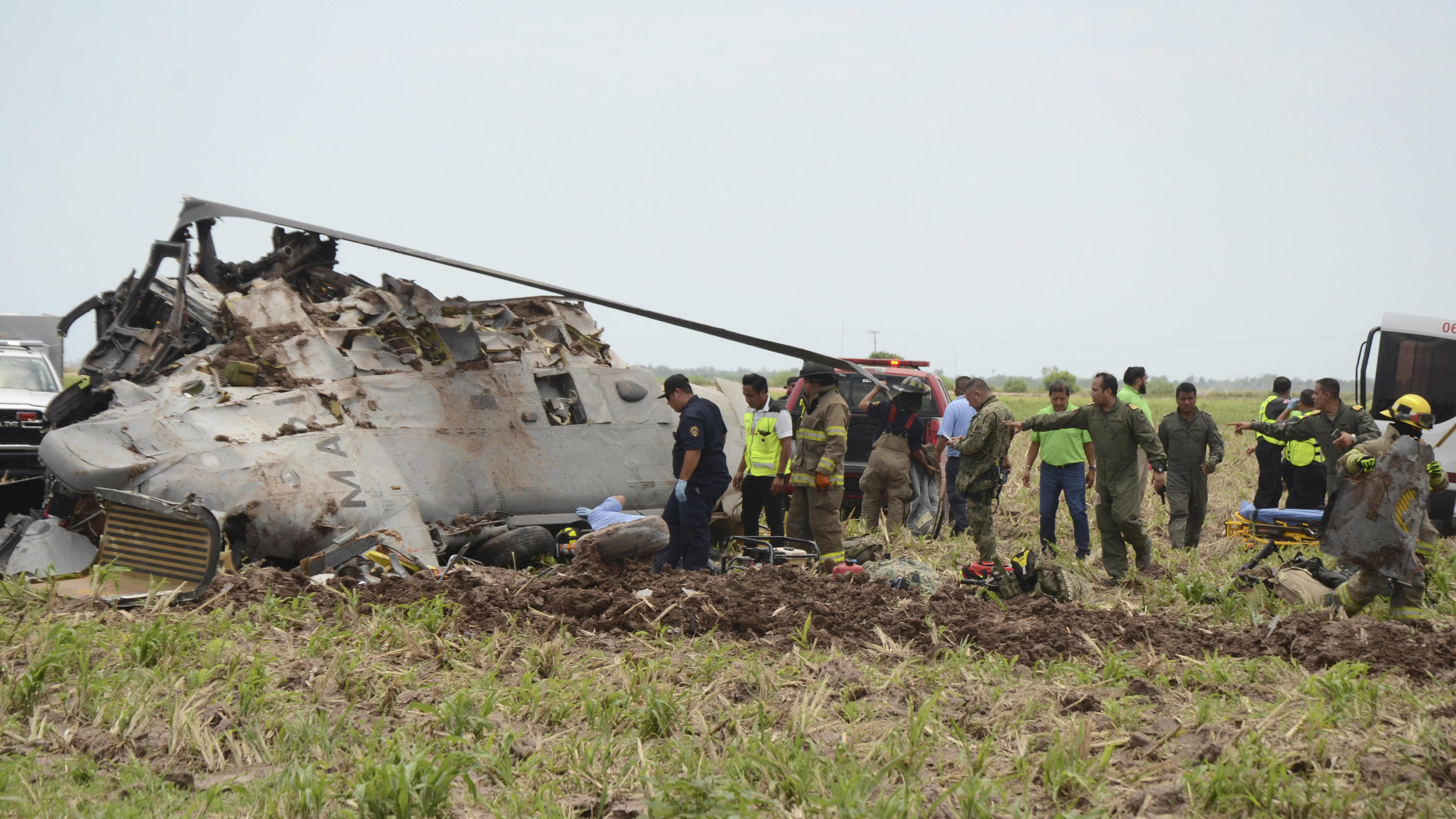 Emergency personnel work next to a navy Blackhawk helicopter crashed after supporting those who conducted the capture of drug lord Rafael Caro Quintero, near Los Mochis, Sinaloa state, Mexico, Friday, July 15, 2022. Mexico's navy said multiple people