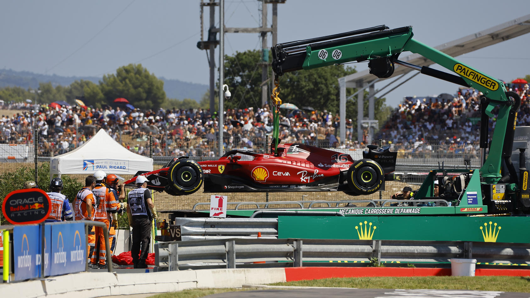 Track marshals remove car of Ferrari driver Charles Leclerc