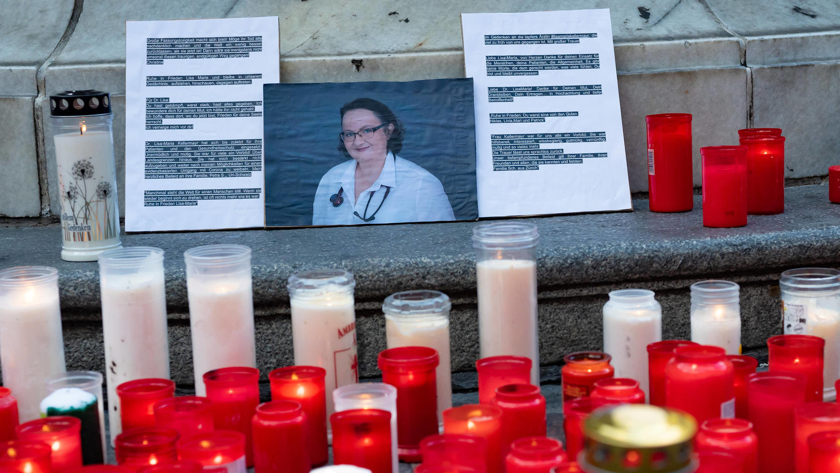  linz, austria, 01 aug 2022, flowers and burning candles lie at a memorial in memory of upper austrian doctor Lisa-Maria Kellermayr at the place taubenmarkt. the doctor was found dead after comitting suicide in her ordination, which was closed due to
