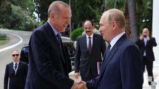 Russian President Vladimir Putin, right, greets Turkish President Recep Tayyip Erdogan upon his arrival at the Rus sanatorium in the Black Sea resort of Sochi, Russia, Friday, Aug. 5, 2022. Erdogan's spokesman Ibrahim Kalin is the center. Turkish President Recep Tayyip Erdogan traveled to Russia Friday for talks with Russian President Vladimir Putin expected to focus on a grain deal brokered by Turkey, prospects for talks on ending hostilities in Ukraine, and the situation in Syria. (Vyacheslav Prokofyev, Sputnik, Kremlin Pool Photo via AP)