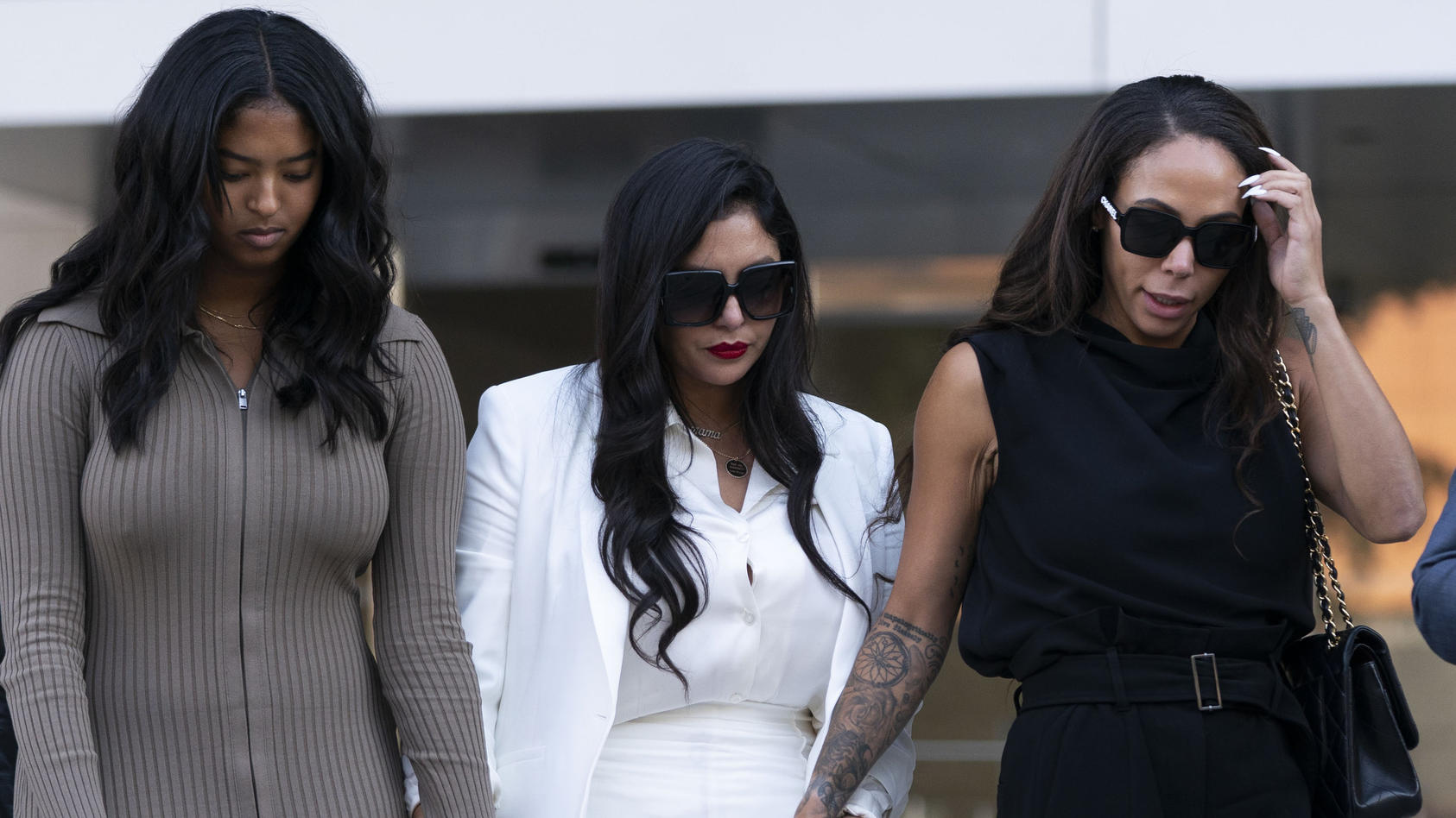 Vanessa Bryant, center, Kobe Bryant's widow, leaves a federal courthouse with her daughter, Natalia, left, and soccer player Sydney Leroux in Los Angeles, Wednesday, Aug. 24, 2022. A federal jury has found that Los Angeles County must pay Bryant's wi