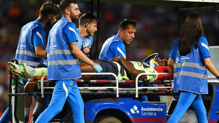 BARCELONA, SPAIN - AUGUST 24: Luke Mbete-Tabu of Manchester City is stretched off after picking up a injury during the friendly match between FC Barcelona and Manchester City at Camp Nou on August 24, 2022 in Barcelona, Spain. (Photo by David Ramos/Getty Images)
