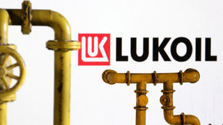 FILE PHOTO: Model of natural gas pipeline and Lukoil logo, July 18, 2022. REUTERS/Dado Ruvic/Illustration/File Photo
