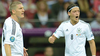 Germany's Bastian Schweinsteiger (L) and Mesut Oezil react during the UEFA EURO 2012 semi-final soccer match Germany vs. Italy at the National Stadium in Warsaw, Poland, 28 June 2012. Photo: Andreas Gebert dpa (Please refer to chapters 7 and 8 of http://dpaq.de/Ziovh for UEFA Euro 2012 Terms & Conditions)  +++(c) dpa - Bildfunk+++